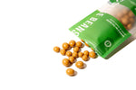 The green Chocolate Covered Coffee Bean pouch lays on its side, with coffee beans spilling out.
